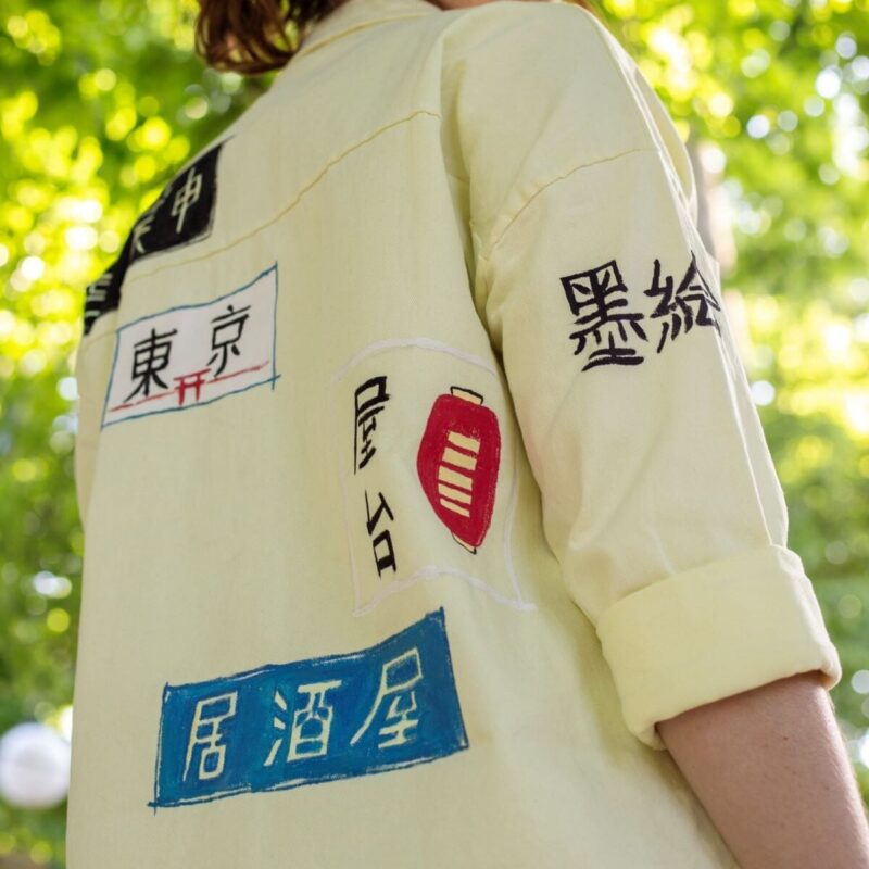Light yellow jean jacket with japanese signage