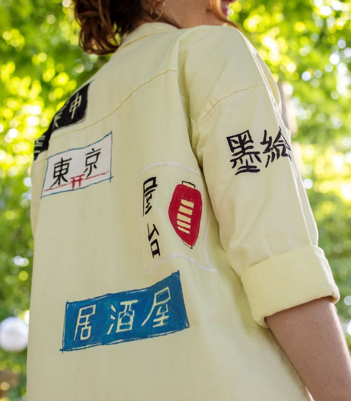 Light yellow jean jacket with japanese signage
