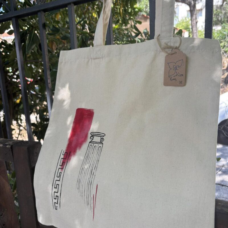 Hand-painted beige canvas tote bag featuring a minimalist ancient Greek column with a bold red brushstroke in Japanese sumi-e inspired style.