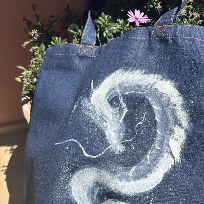 Hand-painted denim tote bag featuring a white Eastern dragon in a Japanese brush painting style.
